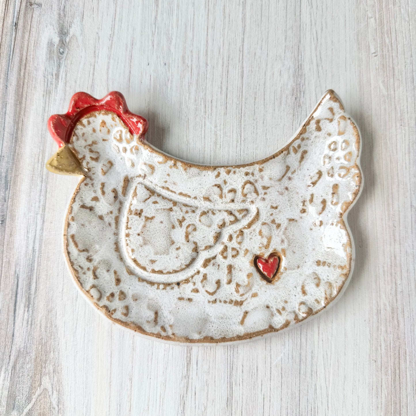 Chicken w/a heart spoon rest, white on brown clay